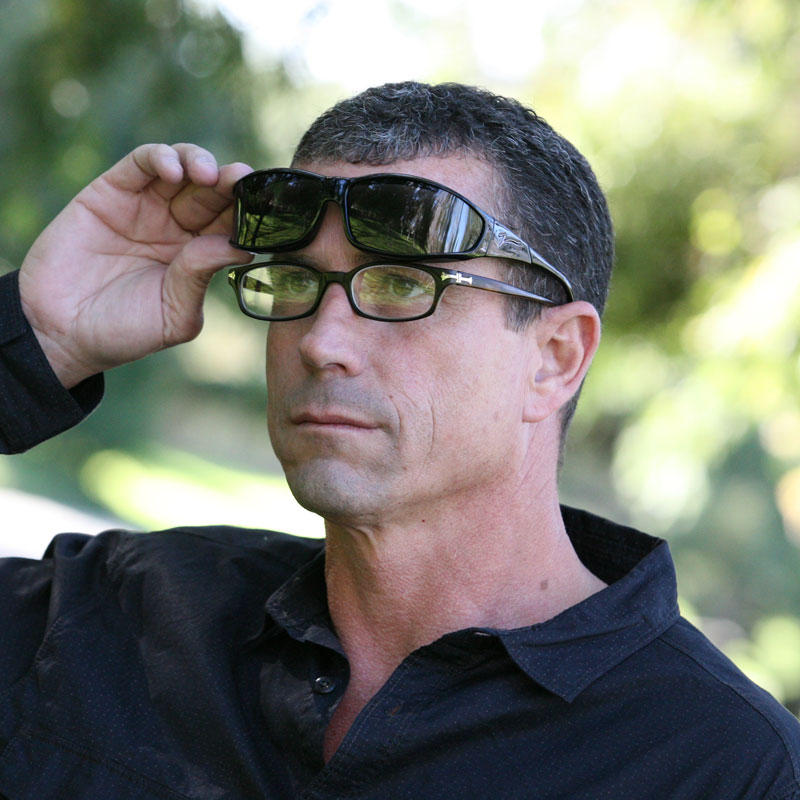 Jon is wearing polarized fitover sunglasses that go over regular glasses. The fashionable design makes them easy to wear over prescription eyeglasses.