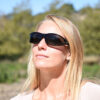 Woman wears tortoise vistana fit overs over prescription eyewear.