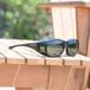 Black fitover sunglasses on deck chair